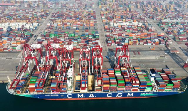 A container ship is seen at berth at the container terminal of the port in Qingdao, in China’s eastern Shandong province on April 2, 2026. (Photo by CN-STR / AFP) / China OUT