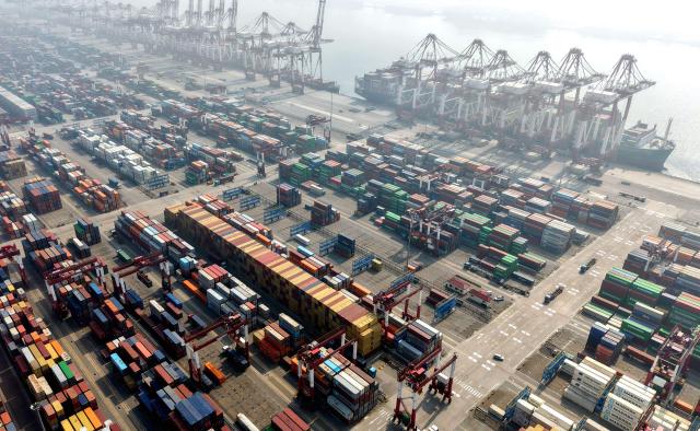 Cargo ships and containers are seen at the container terminal of the port in Qingdao, in China’s eastern Shandong province on April 2, 2026. (Photo by CN-STR / AFP) / China OUT