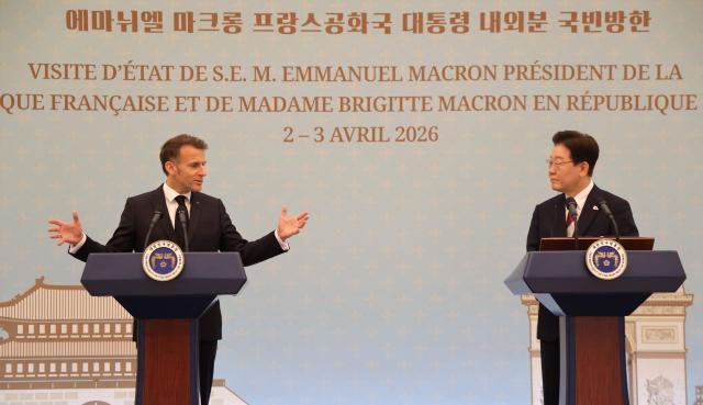 French President Emmanuel Macron (L) and South Korean President Lee Jae-myung speak at a joint press conference following their bilateral meeting in Seoul on April 3, 2026. (Photo by Ludovic MARIN / AFP)