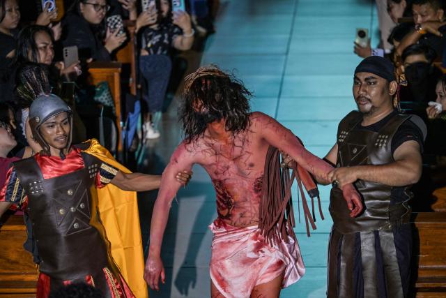 Indonesian Catholics reenact the crucifixion of Jesus Christ at the compound of St. Vincent A Paulo church in Surabaya, eastern Java island on April 3, 2026, as Christian devotees mark the holy week in Indonesia, a predominantly Muslim nation. (Photo by JUNI KRISWANTO / AFP)