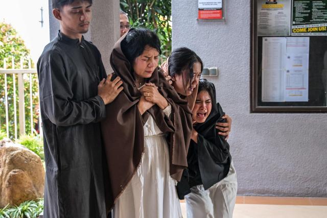 Indonesian Catholics reenact the crucifixion of Jesus Christ at the compound of St. Vincent A Paulo church in Surabaya, eastern Java island on April 3, 2026, as Christian devotees mark the holy week in Indonesia, a predominantly Muslim nation. (Photo by JUNI KRISWANTO / AFP)