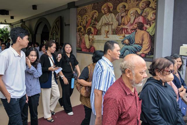 Indonesian Catholics leave after attending a reenactment of the crucifixion of Jesus Christ at the compound of St. Vincent A Paulo church in Surabaya, eastern Java island on April 3, 2026, as Christian devotees mark the holy week in Indonesia, a predominantly Muslim nation. (Photo by JUNI KRISWANTO / AFP)