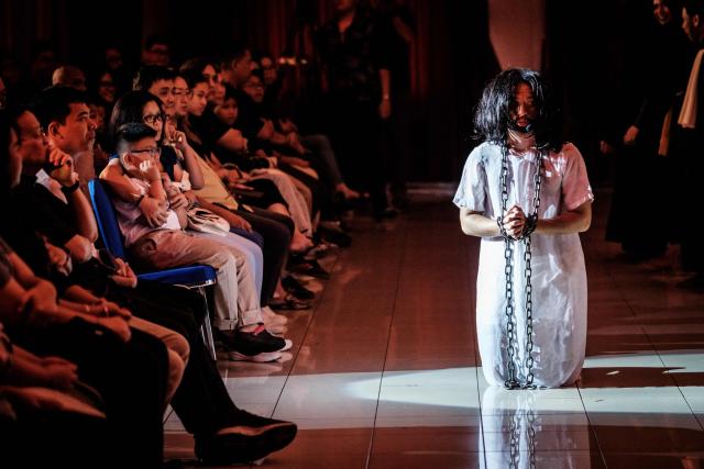 Catholics take part in a reenactment of the Passion of Christ on Good Friday at St. Bonaventura Church in Jakarta on April 3, 2026, as Christian devotees mark the Holy Week in Indonesia, a predominantly Muslim nation. (Photo by Yasuyoshi Chiba / AFP)
