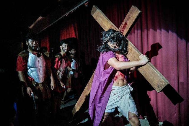Catholics take part in a reenactment of the Passion of Christ on Good Friday at St. Bonaventura Church in Jakarta on April 3, 2026, as Christian devotees mark the Holy Week in Indonesia, a predominantly Muslim nation. (Photo by Yasuyoshi Chiba / AFP)