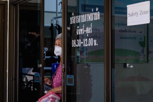 Watwilai Chaiwan enters a "dust-free room, equipped with air purifiers and positive pressure systems that keep out the polluted air, at a retirement facility where she lives in Chiang Mai on April 2, 2026. Seasonal agricultural burning, forest fires and weather patterns produce an annual pollution season across much of Southeast Asia. But parts of northern Thailand are seeing haze that even hardened locals say is exceptional. (Photo by ANTHONY WALLACE / AFP) / To go with 'Thailand-Pollution-Environment-Fire-Health' Reportage by Chayanit ITTHIPONGMAETEE