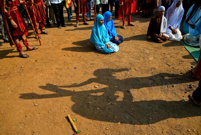 Christians re-enact the crucifixion of Jesus Christ during a Good Friday procession inside the Dharavi slums in Mumbai on April 3, 2026. (Photo by Indranil MUKHERJEE / AFP)
