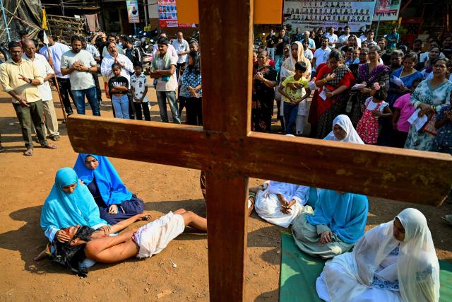 Christians re-enact the crucifixion of Jesus Christ during a Good Friday procession inside the Dharavi slums in Mumbai on April 3, 2026. (Photo by Indranil MUKHERJEE / AFP)