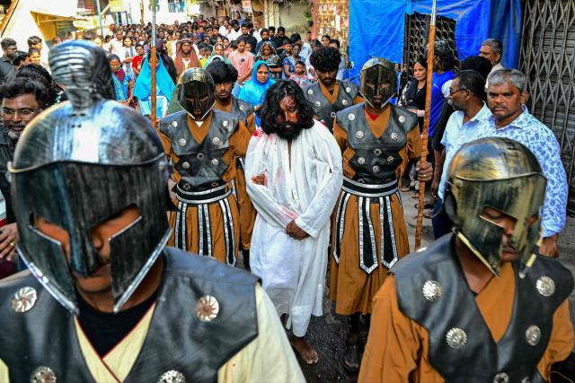 Christians re-enact the crucifixion of Jesus Christ during a Good Friday procession inside the Dharavi slums in Mumbai on April 3, 2026. (Photo by Indranil MUKHERJEE / AFP)