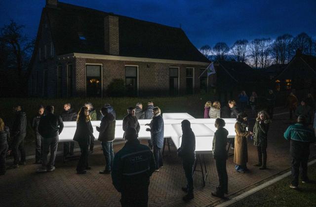 Cross-bearers attendees and spectators stand next to an illuminated cross as they take part in The Passion, a Dutch passion play, broadcasted live by the KRO-NCRV company, in Dwingeloo, The Netherlands, on April 2, 2026. (Photo by Jilmer Postma / ANP / AFP) / Netherlands OUT