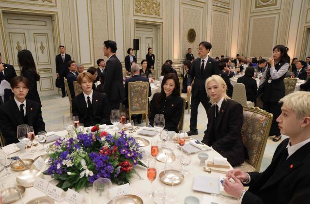 K-pop singers and artists attend a state lunch with French President Emmanuel Macron and South Korean President Lee Jae-myung (both not pictured), in Seoul on April 3, 2026. (Photo by Ludovic MARIN / AFP)
