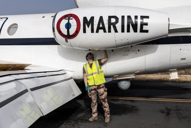 A member of the French Navy cleans a Falcon 50 aircraft after a joint patrol against illicit maritime activities alongside the Cape Verdean Coast Guards in Praia, Cape Verde, on April 2, 2026. A Falcon 50 aircraft has been deployed to Cape Verde as part of France’s mission to reinforce maritime security in the Gulf of Guinea through the CORYMBE Mission and to combat illicit maritime activities such as illegal, unreported and unregulated (IUU) fishing, drug trafficking or piracy. (Photo by PATRICK MEINHARDT / AFP)