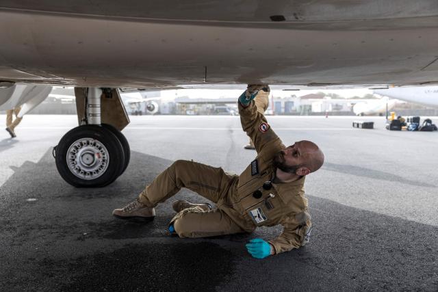 A member of the French Navy cleans a Falcon 50 aircraft after a joint patrol against illicit maritime activities alongside the Cape Verdean Coast Guards in Praia, Cape Verde, on April 2, 2026. A Falcon 50 aircraft has been deployed to Cape Verde as part of France’s mission to reinforce maritime security in the Gulf of Guinea through the CORYMBE Mission and to combat illicit maritime activities such as illegal, unreported and unregulated (IUU) fishing, drug trafficking or piracy. (Photo by PATRICK MEINHARDT / AFP)