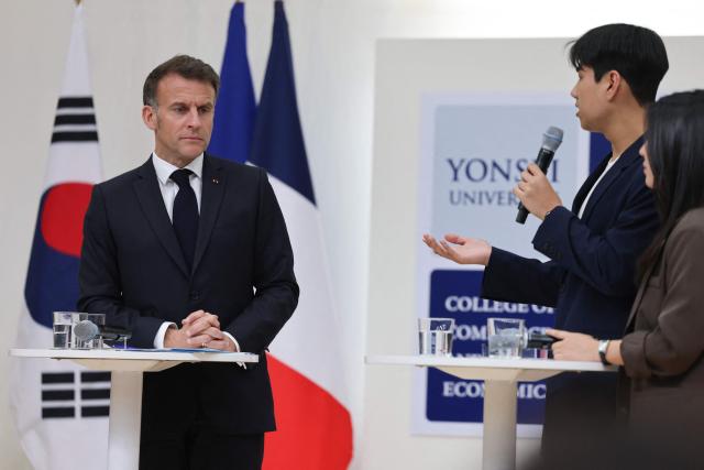 French President Emmanuel Macron attends a meeting with students at Yonsei University in Seoul on April 3, 2026. (Photo by Ludovic MARIN / AFP)