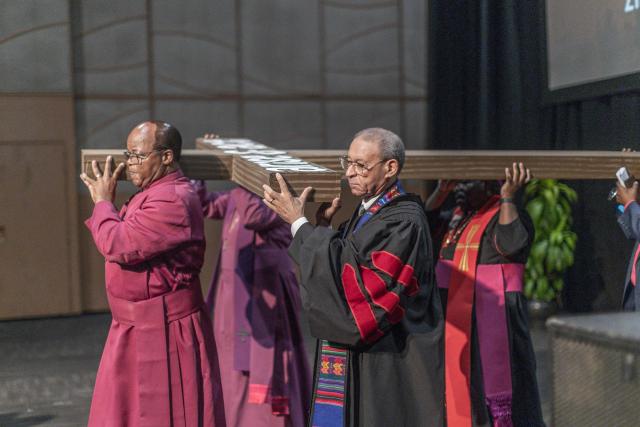 Clergymen from different Christian denominations carry a wooden cross from the International Convention Centre (ICC) during the Good Friday procession to the Durban City Hall in Durban on April 3, 2026. (Photo by RAJESH JANTILAL / AFP)
