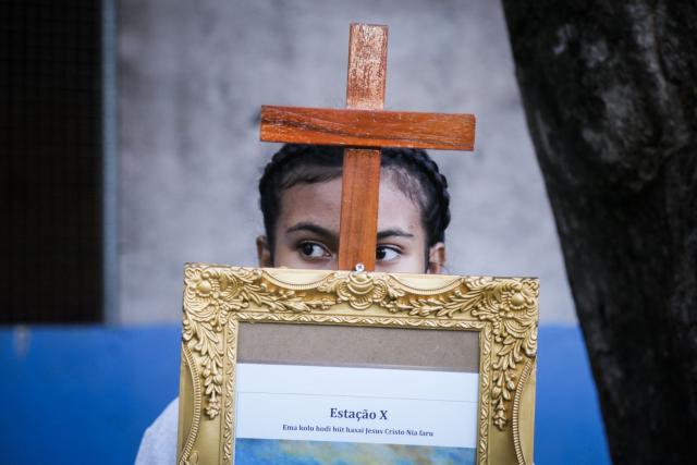 A Catholic devotee takes part in a Good Friday procession from Balide Church in Dili on April 3, 2026. (Photo by VALENTINO DARIELL DE SOUSA / AFP)