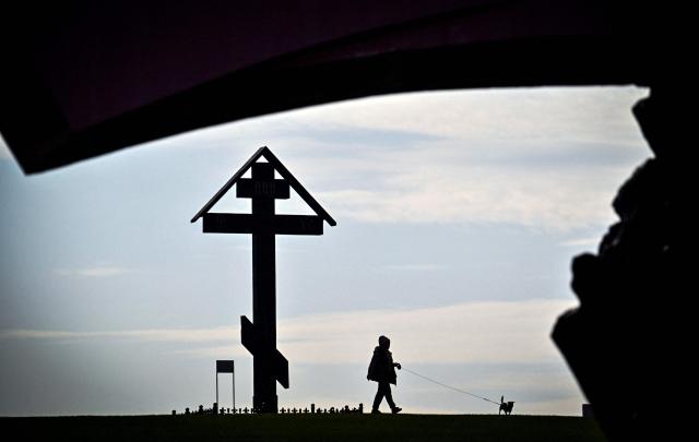 A woman walks her pet near the Museum of the Great Patriotic War (also known as the Victory Museum ) at Poklonnaya Hill in western Moscow on April 3, 2026. (Photo by Alexander NEMENOV / AFP)