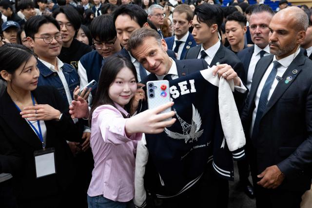 French President Emmanuel Macron attends a meeting with students at Yonsei University in Seoul on April 3, 2026. (Photo by Jeanne Accorsini / POOL / AFP)