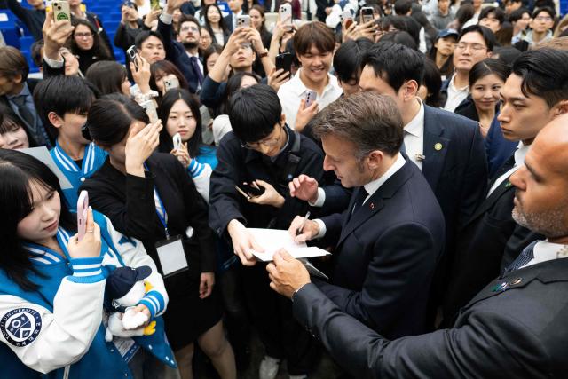French President Emmanuel Macron attends a meeting with students at Yonsei University in Seoul on April 3, 2026. (Photo by Jeanne Accorsini / POOL / AFP)