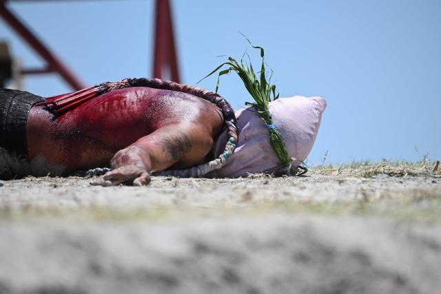 EDITORS NOTE: Graphic content / A penitent prostrates in front of the crosses prior to the annual crucifixion during the observance of Lent in the village of Cutud in San Fernando, Pampanga province on April 3, 2026. Devotees in the fervently Catholic Philippines marked Good Friday by being nailed to crosses and whipping their backs bloody, in extreme acts of devotion that attracted thousands of spectators. (Photo by Ted ALJIBE / AFP)