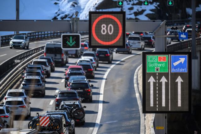 Easter holidaymakers queue in their cars on the A2 motorway on their way to the northern entrance of the Gotthard Road Tunnel near the village of Wassen, on April 3, 2026, as traffic builds up to a 19-kilometre jam with a waiting time of around 190 minutes, according to the Touring Club Suisse (TCS). (Photo by Fabrice COFFRINI / AFP)