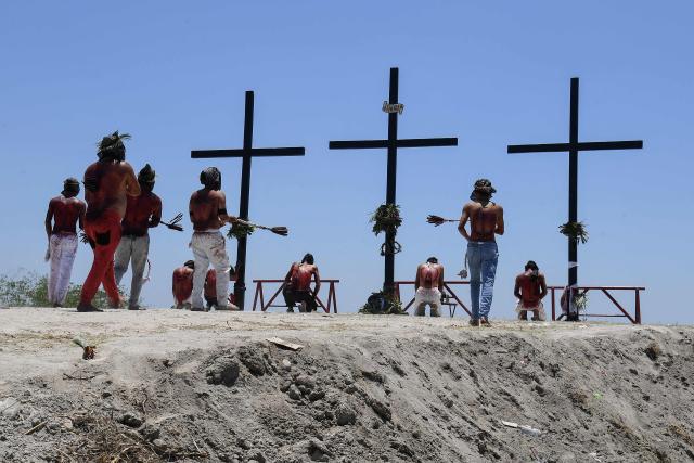 EDITORS NOTE: Graphic content / Penitents flagellate themselves in front of the crosses prior to the annual crucifixion during the observance of Lent in the village of Cutud in San Fernando, Pampanga province on April 3, 2026. Devotees in the fervently Catholic Philippines marked Good Friday by being nailed to crosses and whipping their backs bloody, in extreme acts of devotion that attracted thousands of spectators. (Photo by Ted ALJIBE / AFP)