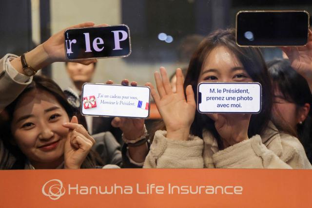 People wait for the arrival of French President Emmanuel Macron before the inauguration of the Centre Pompidou Hanwha in Seoul on April 3, 2026. (Photo by Ludovic MARIN / AFP)