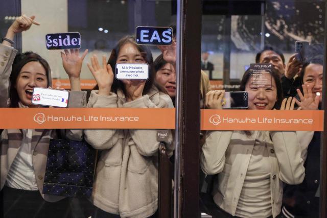 People wait for the arrival of French President Emmanuel Macron before the inauguration of the Centre Pompidou Hanwha in Seoul on April 3, 2026. (Photo by Ludovic MARIN / AFP)
