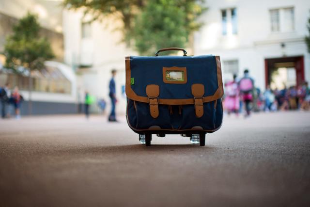 (FILES) A schoolbag is pictured in the courtyard of a primary school on September 3, 2013 in Paris, on the first day of school. More than 12 million pupils went back to school today in France. Paris has suspended 31 school monitors suspected of sexual abuse since January, Paris' Mayor Emmanuelle Gregoire said on April 3, 2026. (Photo by MARTIN BUREAU / AFP)