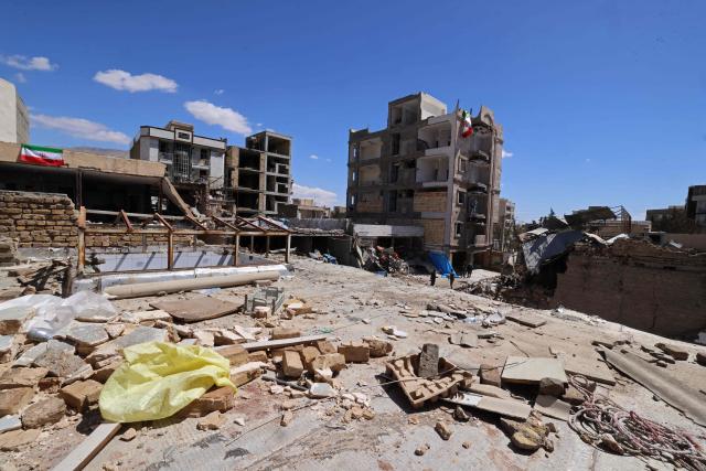 Residential building that were damaged by recent strikes are pictured at Vahdat town in Karaj, southwest of Tehran on April 3, 2026. Iran and its allies traded fire with Israel and the United States, as Washington-linked assets across the Middle East were targeted alongside civilian infrastructure -- with the month-long war on April 3 showing little sign of easing. (Photo by ATTA KENARE / AFP) / 