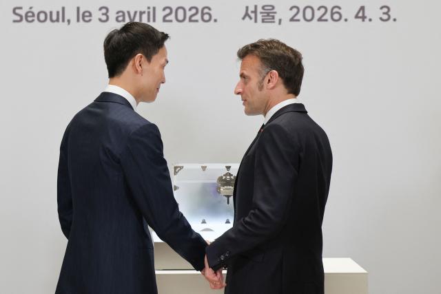 Hanwha Life CEO Kim Dong-won and French President Emmanuel Macron attend the inauguration of the Centre Pompidou Hanwha in Seoul on April 3, 2026. (Photo by Ludovic MARIN / AFP)