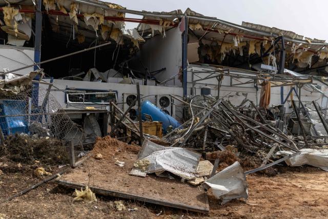 A picture shows the damage at a factory that got hit by a missile in Petah Tikva, east of Tel Aviv, on April 3, 2026. Israel said it was under attack from a new barrage of Iranian missiles, as US President Donald Trump warned Washington had yet to begin "destroying what's left" of Iran's infrastructure. The war started more than a month ago with US-Israeli strikes on Iran, triggering retaliation that spread the conflict throughout the Middle East, convulsing the global economy and impacting millions of people worldwide. (Photo by Ilia YEFIMOVICH / AFP) / 