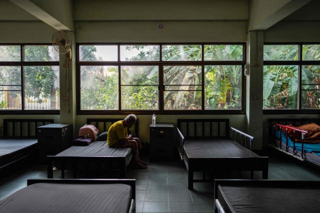 A man rests inside a "dust-free room”, equipped with air purifiers and positive pressure systems (top C) that keep out the polluted air at a retirement facility in Chiang Mai on April 2, 2026. (Photo by ANTHONY WALLACE / AFP)