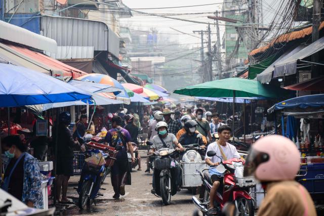People visit a market on a heavily polluted day in Chiang Mai on April 2, 2026. (Photo by ANTHONY WALLACE / AFP)