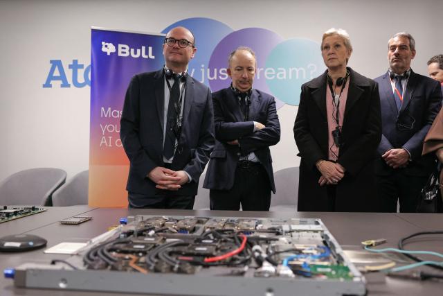 France’s junior Minister for Industry Sebastien Martin (L), France’s junior Minister in charge of artificial intelligence Anne Le Henanff (2nd R) and Bull Managing Director Emmanuel Leroux (2nd L) are given a presentation of components in a research and development laboratory during a visit to the site of IT company Bull in Les-Clayes-sous-Bois on April 3, 2026. Bull, which manufactures supercomputers among other products, announced its plan to hire 500 people in 2026, mainly in Europe, after being acquired by the French government and spun off from the Atos group. (Photo by Thomas SAMSON / AFP)
