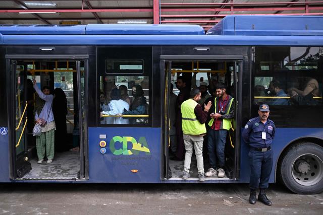 Passengers gather aboard a government bus at a bus stop in Islamabad on April 3, 2026. State-run public transport in Pakistan's capital and most populous province will be free for the coming month, officials said on April 3, after the government drastically raised fuel prices due to spiking global energy prices caused by the Iran war. (Photo by Farooq NAEEM / AFP)