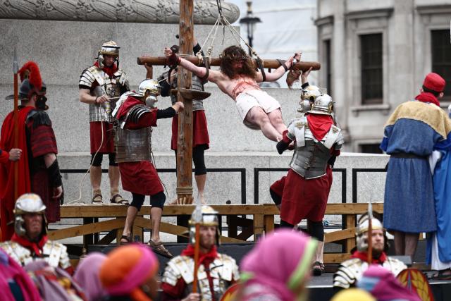 Christ is lifted onto the cross during a performance of Wintershall's 'The Passion of Jesus' on Good Friday in Trafalgar Square in London, on April 3, 2026. (Photo by Henry NICHOLLS / AFP)