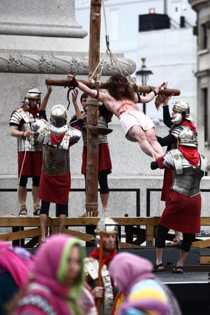 Christ is lifted onto the cross during a performance of Wintershall's 'The Passion of Jesus' on Good Friday in Trafalgar Square in London, on April 3, 2026. (Photo by Henry NICHOLLS / AFP)