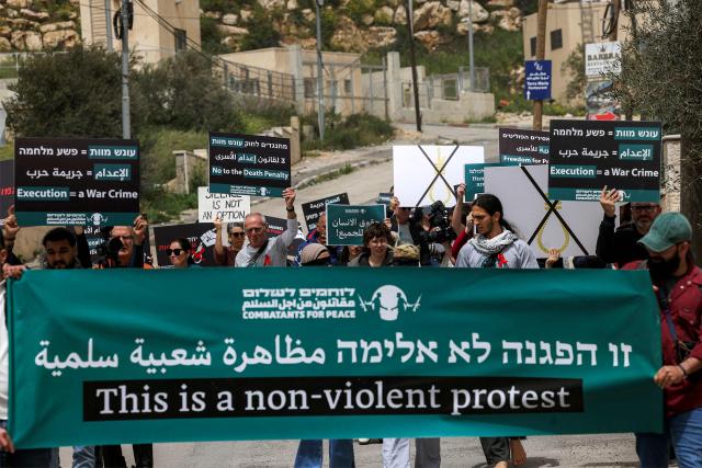 Protesters gather for a demonstration organised by the Israeli and Palestinian "Combatants for Peace" movement, against the recently-approved law allowing the execution of Palestinians convicted on terror charges for deadly attacks, at the Beit Jala North junction in the occupied West Bank on April 3, 2026. Under the new law, passed in parliament late on March 30, Palestinians in the West Bank convicted by military courts of carrying out deadly attacks classified as "terrorism" will face the death penalty as a default sentence. Because Palestinians in the territory are automatically tried in Israeli military courts, the measure effectively creates a separate and harsher legal track. (Photo by HAZEM BADER / AFP)