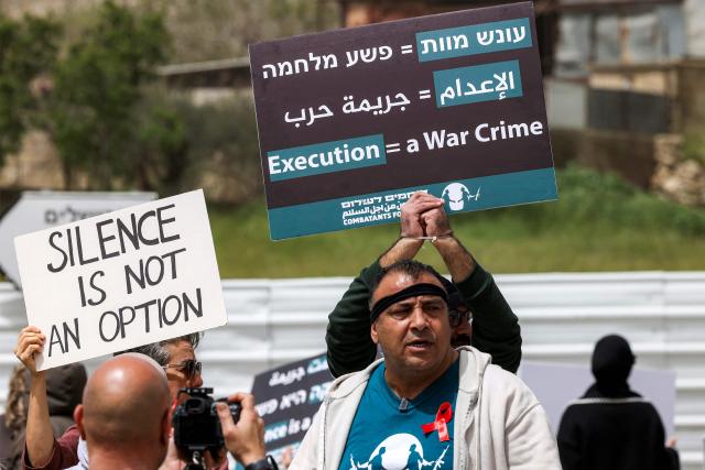 Protesters gather for a demonstration organised by the Israeli and Palestinian "Combatants for Peace" movement, against the recently-approved law allowing the execution of Palestinians convicted on terror charges for deadly attacks, at the Beit Jala North junction in the occupied West Bank on April 3, 2026. Under the new law, passed in parliament late on March 30, Palestinians in the West Bank convicted by military courts of carrying out deadly attacks classified as "terrorism" will face the death penalty as a default sentence. Because Palestinians in the territory are automatically tried in Israeli military courts, the measure effectively creates a separate and harsher legal track. (Photo by HAZEM BADER / AFP)