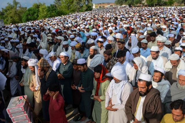Mourners and local residents offer funeral prayers for victims following a suicide car bombing in Bannu, Pakistan's Khyber Pakhtunkhwa province on April 3, 2026. A suicide bomber in a vehicle laden with explosives killed at least three women and two children at a house in northwestern Pakistan late on April 2, local authorities said. (Photo by Karim ULLAH / AFP)