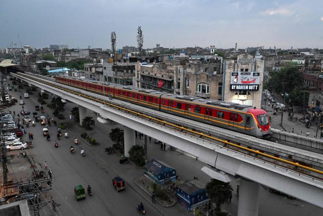 A metro train glides along an elevated track in Lahore on April 3, 2026. State-run public transport in Pakistan's capital and most populous province will be free for the coming month, officials said on April 3, after the government drastically raised fuel prices due to spiking global energy prices caused by the Iran war. (Photo by Arif ALI / AFP)