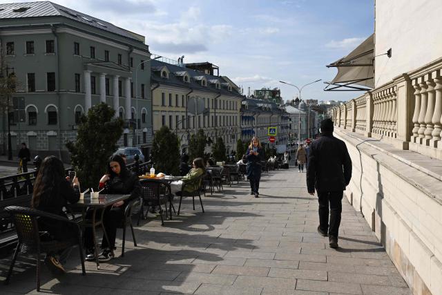 Customers sit on a café's terrace while pedestrians walk by on Rozhdestvensky boulevard in central Moscow, on April 3, 2026 (Photo by Igor IVANKO / AFP)