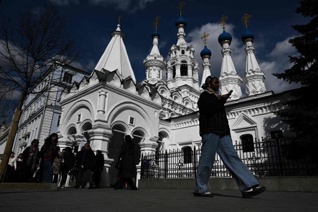 Pedestrians walk along Malaya Dmitrovka street past the Orthodox Church of the Nativity of the Virgin Mary in central Moscow, on April 3, 2026 (Photo by Igor IVANKO / AFP)