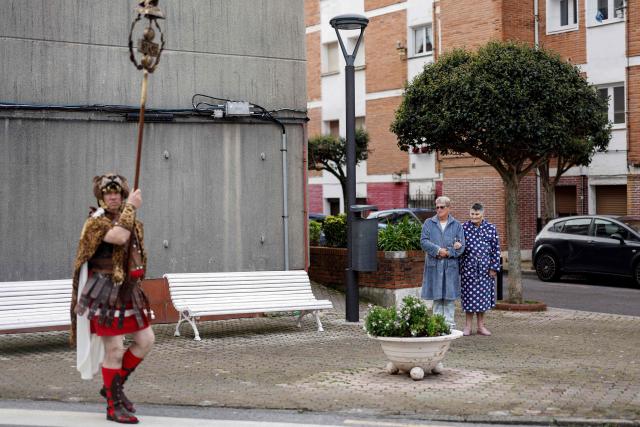 Residents watch as a participant dressed as a Roman takes part in a reenactment of the Passion of Christ in Castro Urdiales in the northern Spain region of Cantabria, on April 3, 2026. Organised by various religious brotherhoods, or "cofradias", centuries-old processions are held across the country in the week leading up to Easter Sunday. (Photo by OSCAR DEL POZO / AFP)