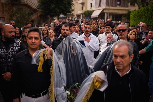 Lebanese Maronite Christian worshippers attend a Good Friday procession near the Saint Maroun Church in the Shiyah neighbourhood of Beirut's southeastern suburbs on April 3, 2026. Lebanon was drawn into the Middle East war on March 2 when Tehran-backed militant group Hezbollah launched attacks on Israel to avenge the killing of the Iranian leader. Israel has responded with broad strikes across Lebanon and a ground offensive. (Photo by Dimitar DILKOFF / AFP)
