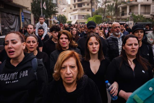 Lebanese Maronite Christian worshippers attend a Good Friday procession near the Saint Maroun Church in the Shiyah neighbourhood of Beirut's southeastern suburbs on April 3, 2026. Lebanon was drawn into the Middle East war on March 2 when Tehran-backed militant group Hezbollah launched attacks on Israel to avenge the killing of the Iranian leader. Israel has responded with broad strikes across Lebanon and a ground offensive. (Photo by Dimitar DILKOFF / AFP)