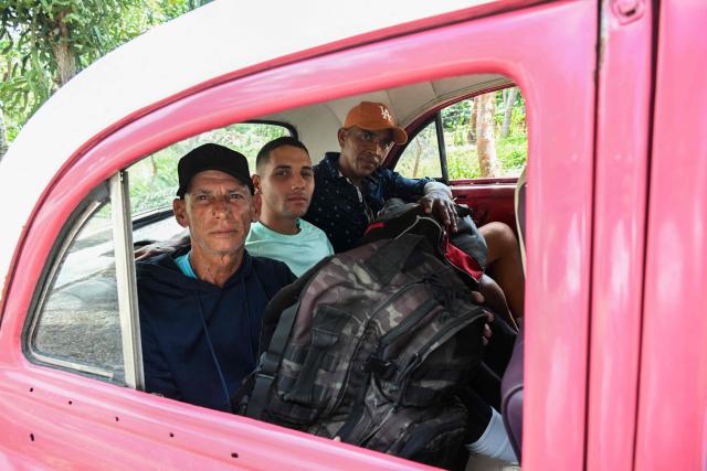 Inmates board a car after walking free from La Lima prison in Havana on April 3, 2026. Cuban authorities began to free prisoners on April 3, 2026, after announcing it would pardon 2,010 inmates, the second release in less than a month as it faces heightened US pressure. (Photo by YAMIL LAGE / AFP)