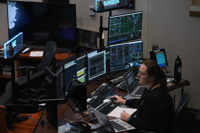 An Artemis II controller monitors the progress of the Orion spacecraft in the White Flight Control Room at Johnson Space Center in Houston, Texas, on April 3, 2026. Four Artemis astronauts were zooming towards the Moon late April 2 after a major engine firing, a milestone that commits NASA to the first crewed lunar flyby in more than half a century. With enough thrust to accelerate a stationary car to highway driving speed in less than three seconds, the Orion capsule engine blasted the astronauts on their trajectory towards the Moon, which they now will loop as part of the 10-day Artemis II mission. (Photo by RONALDO SCHEMIDT / AFP)