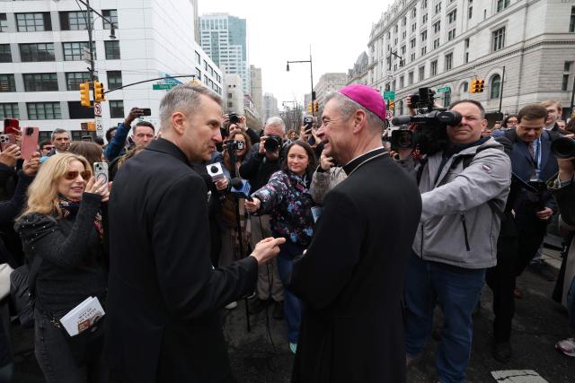 Archbishop of New York Ronald Hicks (L) and Bishop Robert Brennan  of Brooklyn talk to reporters as they participate in the “Way of the Cross” walk on Good Friday April 3, 2026. Christian believers around the world mark the Holy Week of Easter remembering the crucifixion and resurrection of Jesus Christ. (Photo by TIMOTHY A. CLARY / AFP)