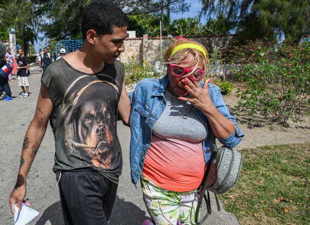 A inmate (L) greets a relative as he walks free from La Lima prison in Havana on April 3, 2026. Cuban authorities began to free prisoners on April 3, 2026, after announcing it would pardon 2,010 inmates, the second release in less than a month as it faces heightened US pressure. (Photo by YAMIL LAGE / AFP)